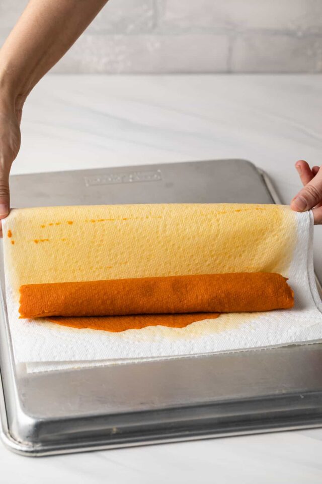Pumpkin puree being rolled off from paper towels