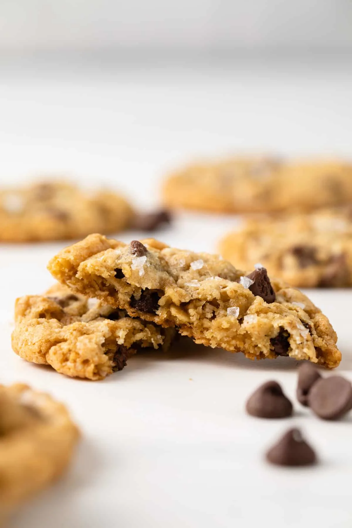 View of a chocolate chip cookie cut in half and stacked on top of each other.