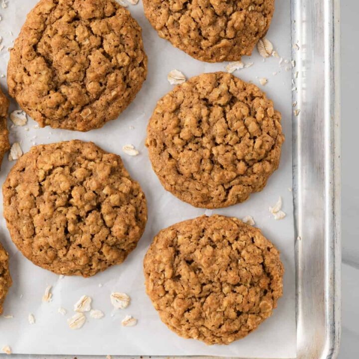 Baked pumpkin oatmeal cookies on baking sheet with parchment paper