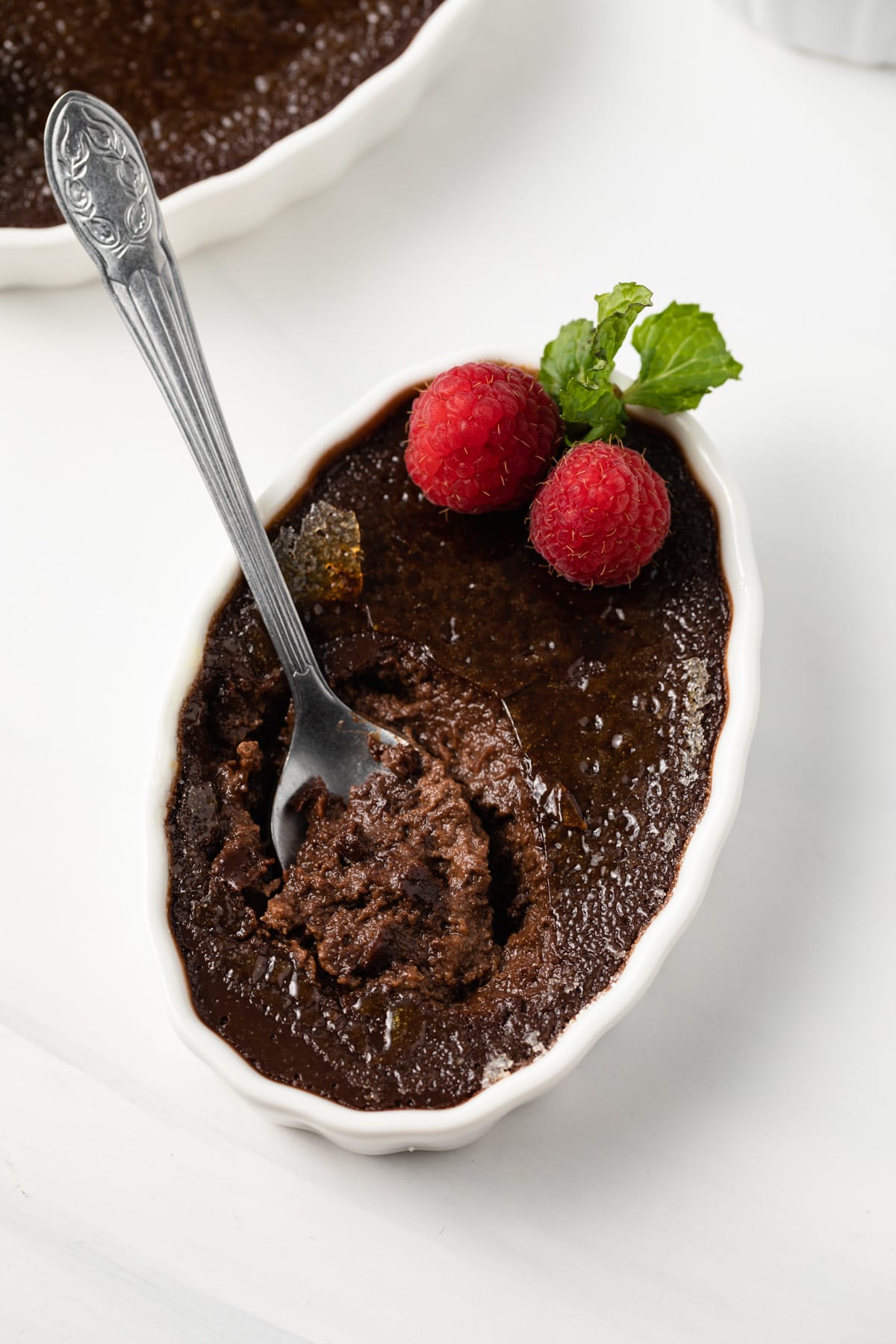 Spoon in chocolate creme brulee.