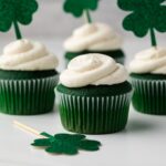 Green velvet cupcakes on countertop.