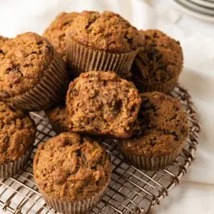 Morning glory muffins with one broken open.