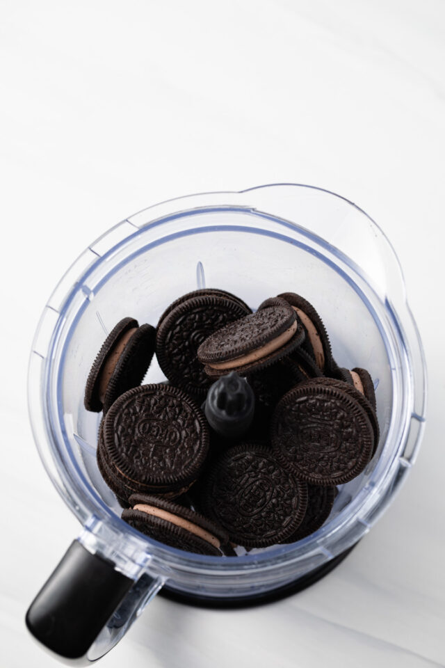Whole chocolate cookies in food processor.