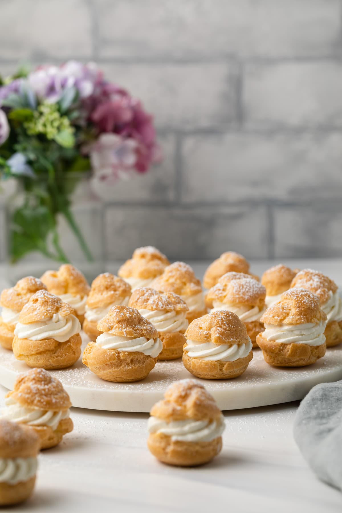 Cream Puffs on marble stand.