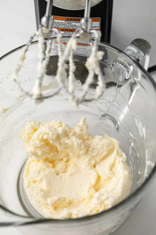 Butter and cream cheese creamed in a glass bowl.