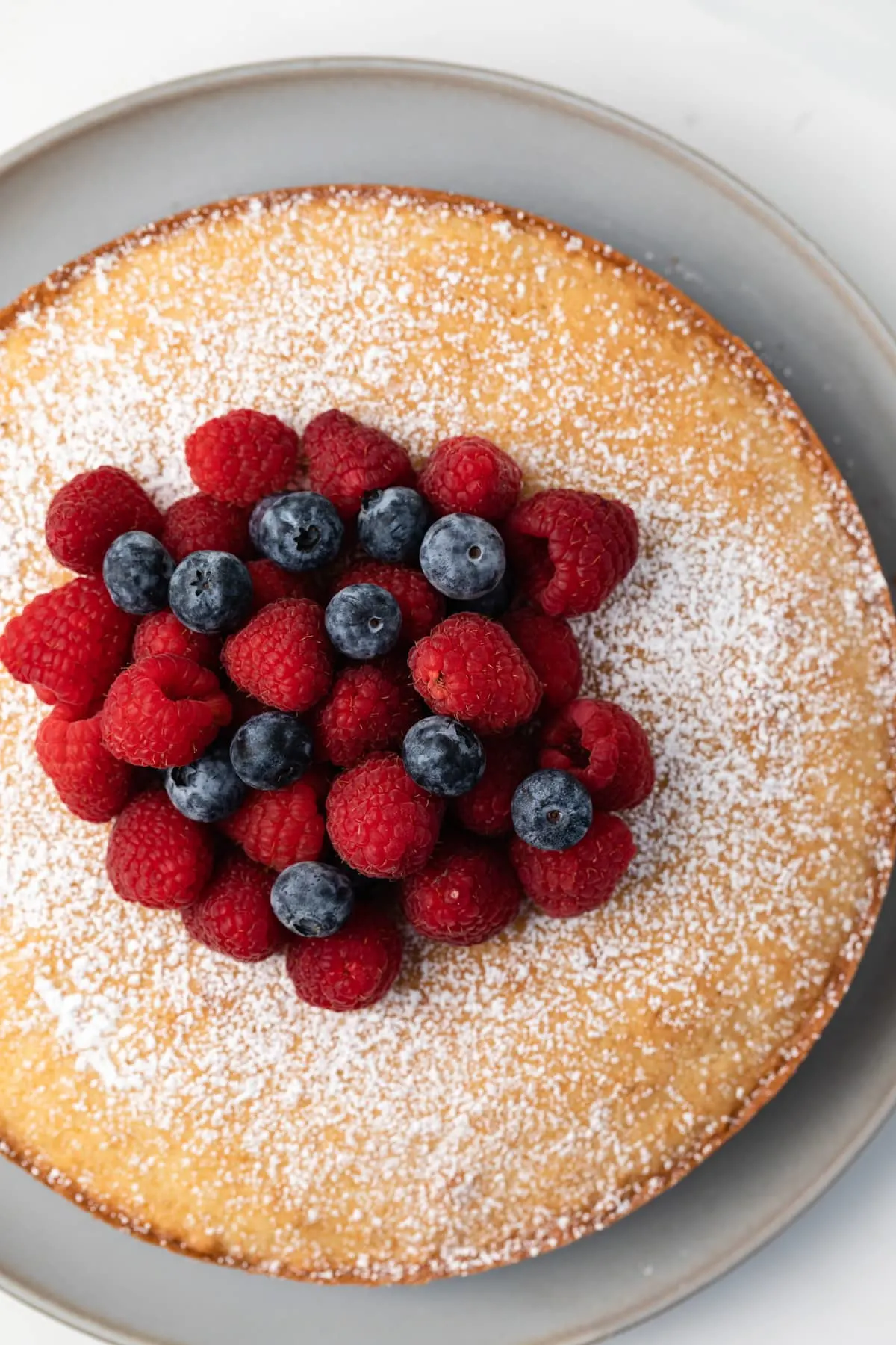 Overhead of Irish tea cake topped with fresh berries.