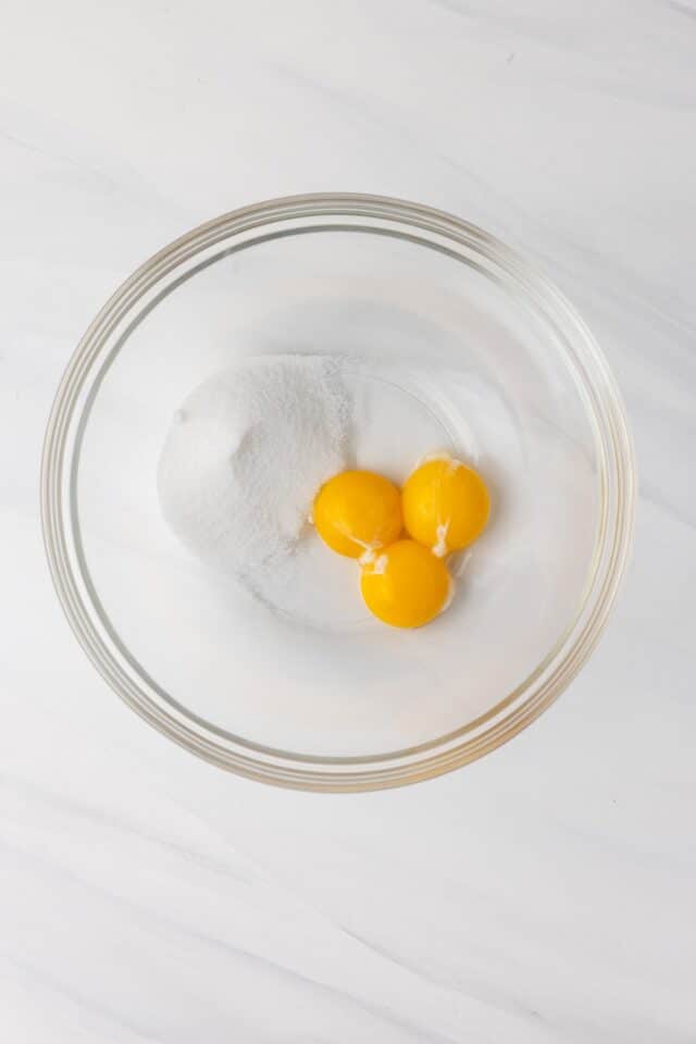 Sugar and egg yolk in bowl.