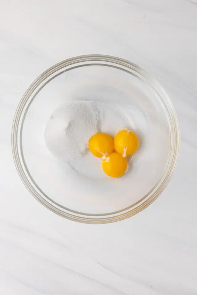 Sugar and egg yolk in bowl.