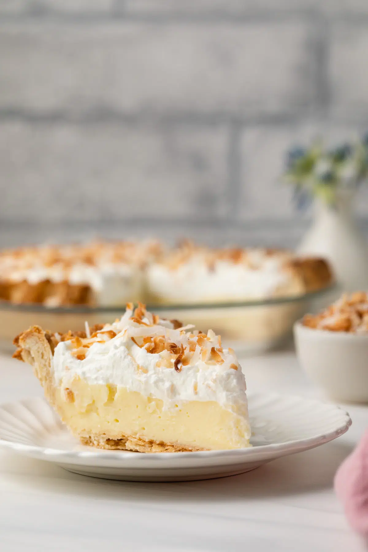 Side view of slice of coconut cream pie.