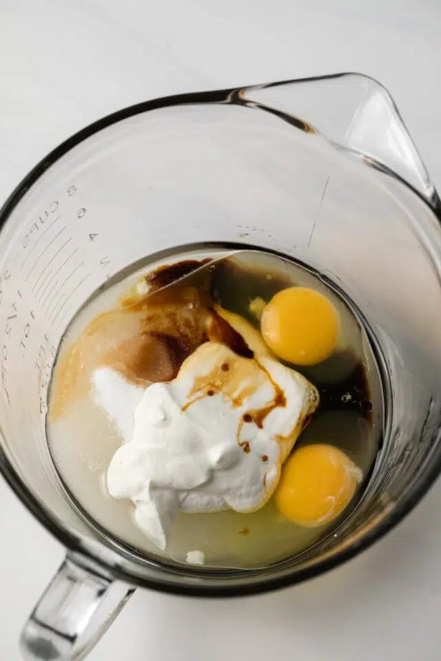 Wet ingredients for cupcakes in a glass bowl.