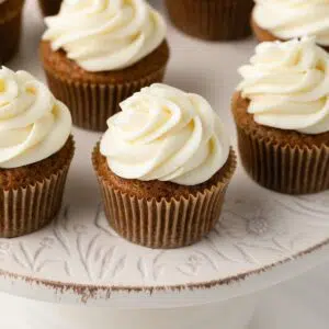 High angled view of carrot cake cupcakes on cake stand.