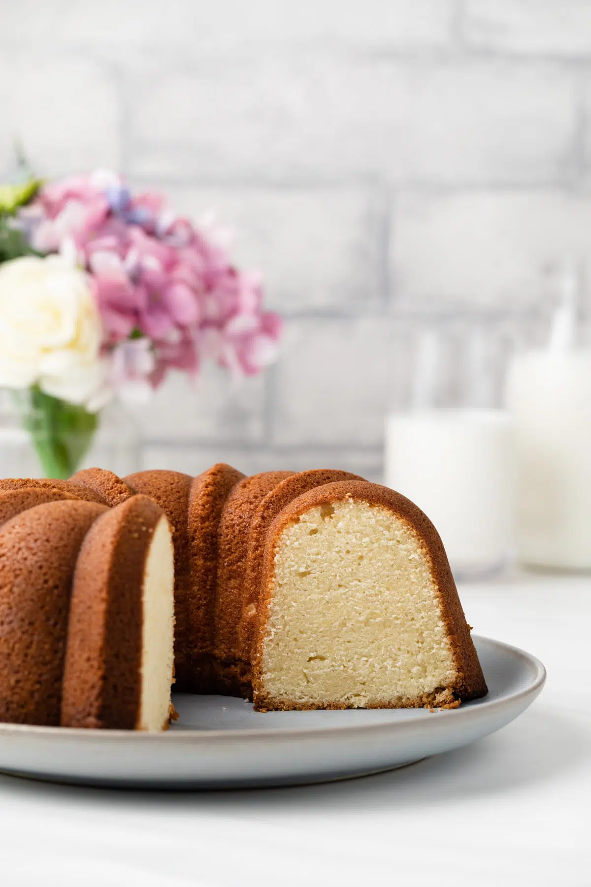 Cream cheese pound cake with slice taken out so inside is visible.