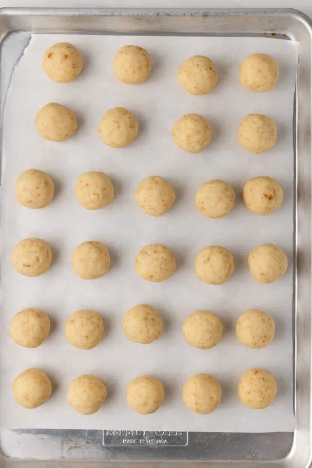Cake pop balls on baking sheet.