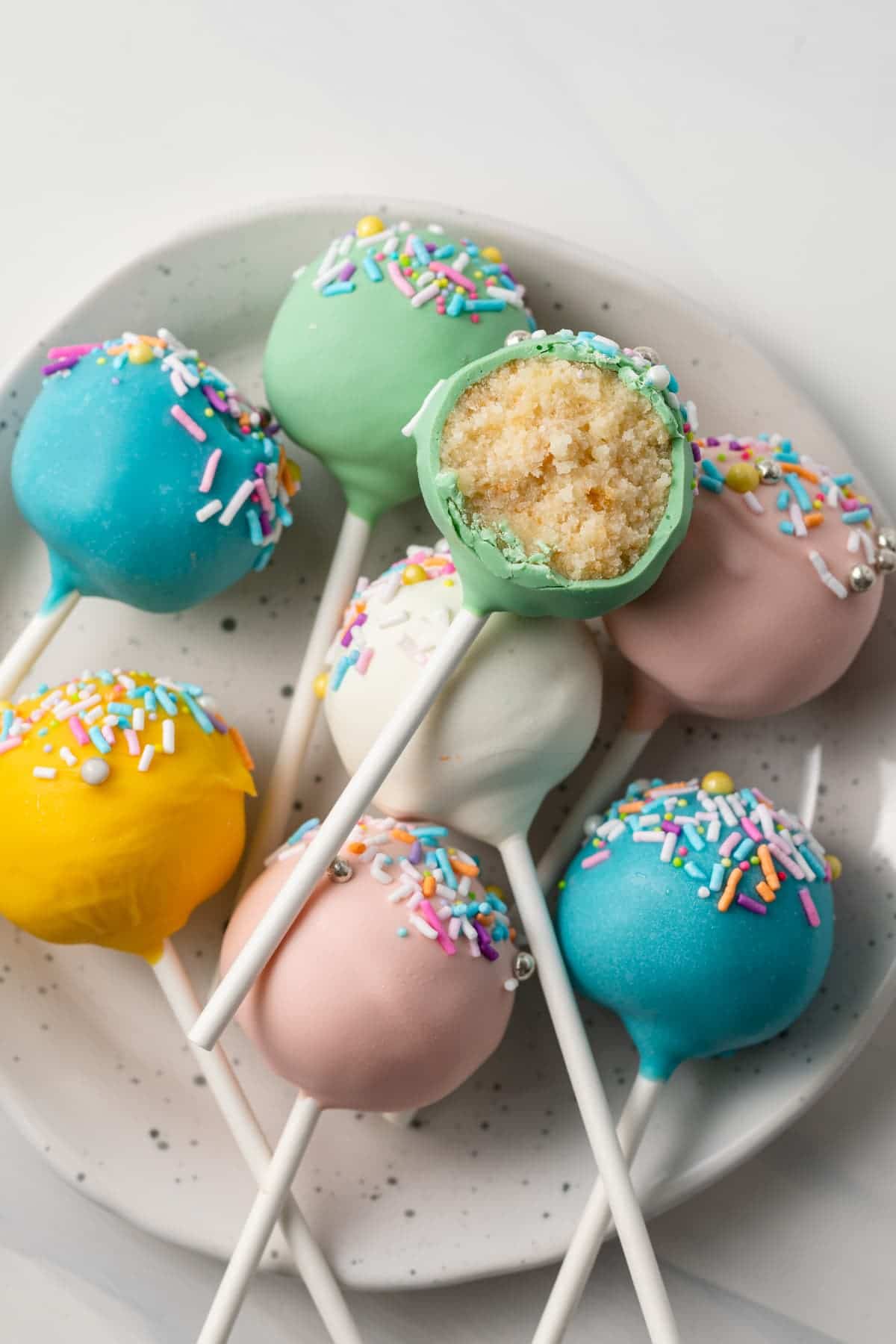 Easter cake pops with a bite taken out of one.