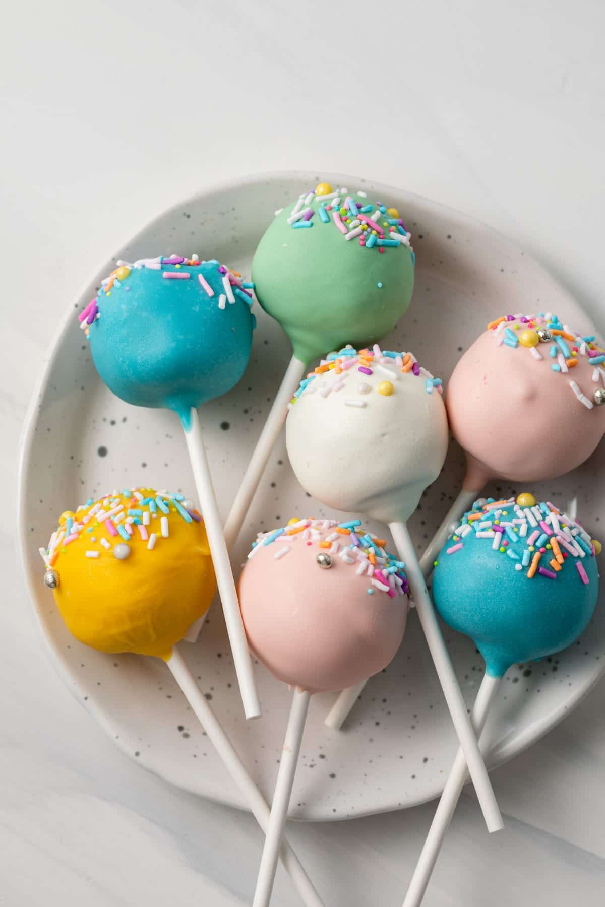 Easter cake pops on a plate.