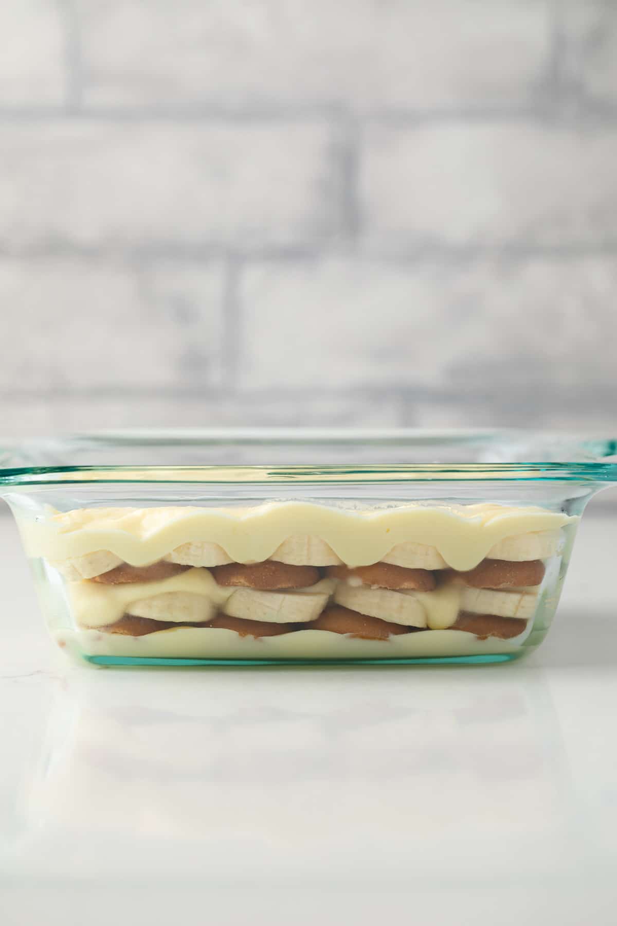 Side view of banana pudding in a glass dish.