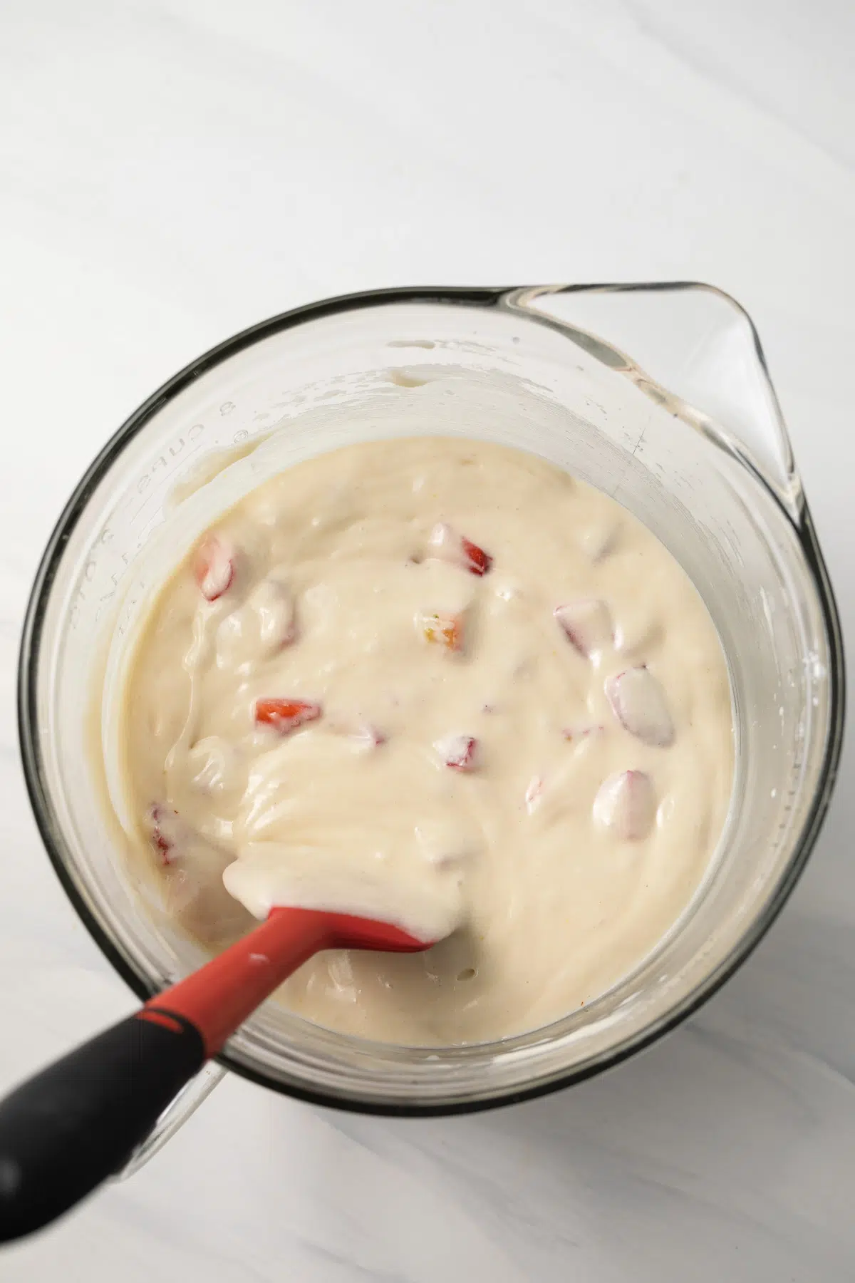 Strawberry cupcake batter in glass bowl.