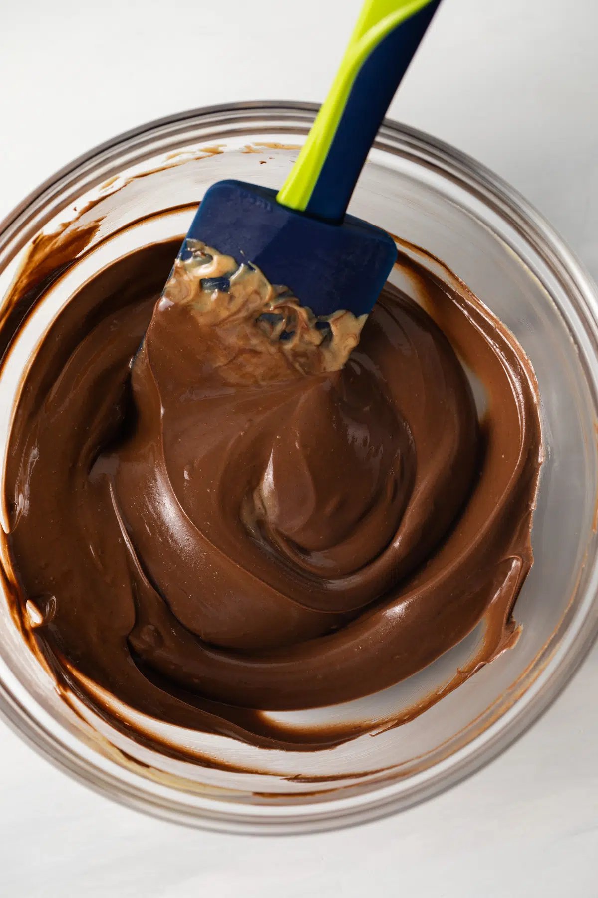 Melted chocolate in glass bowl.