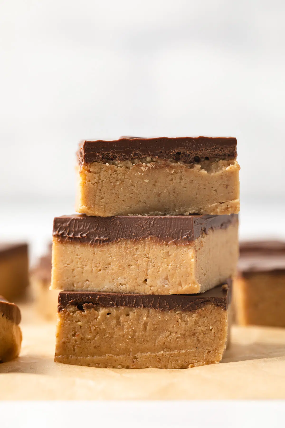 Three no bake peanut butter bars stacked.