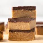 Three no bake peanut butter bars stacked.