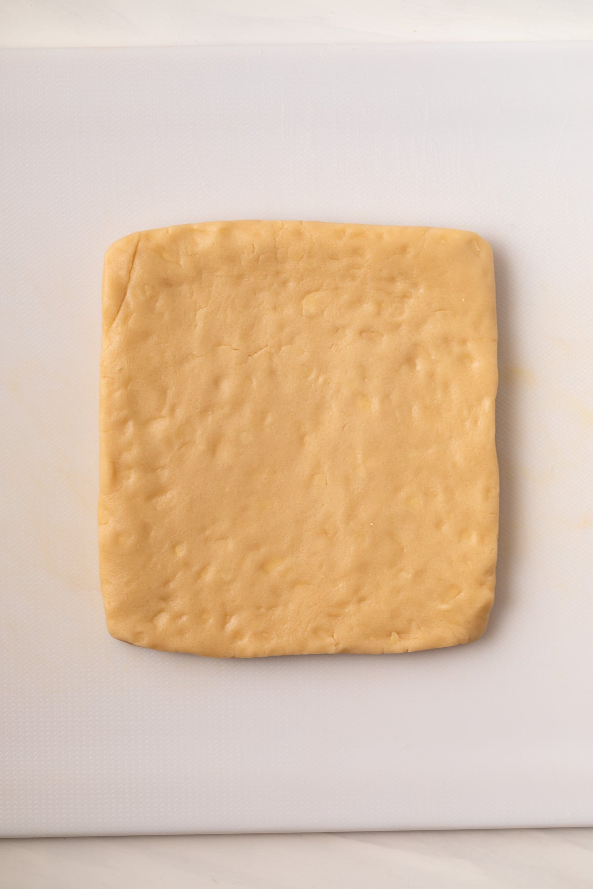 Shortbread dough in a square.