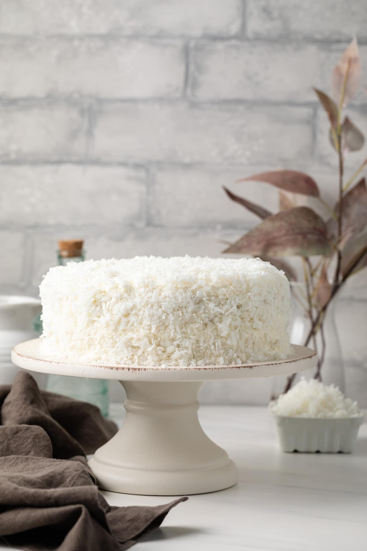 Coconut cake on a cake stand.