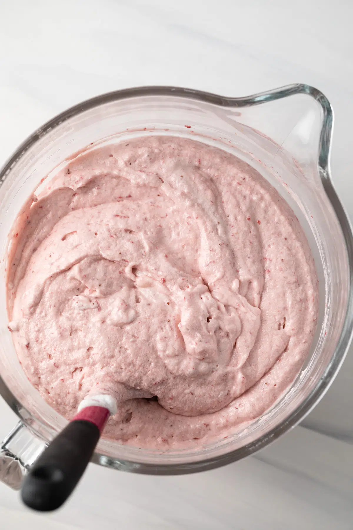 Strawberry cake batter in a glass bowl.