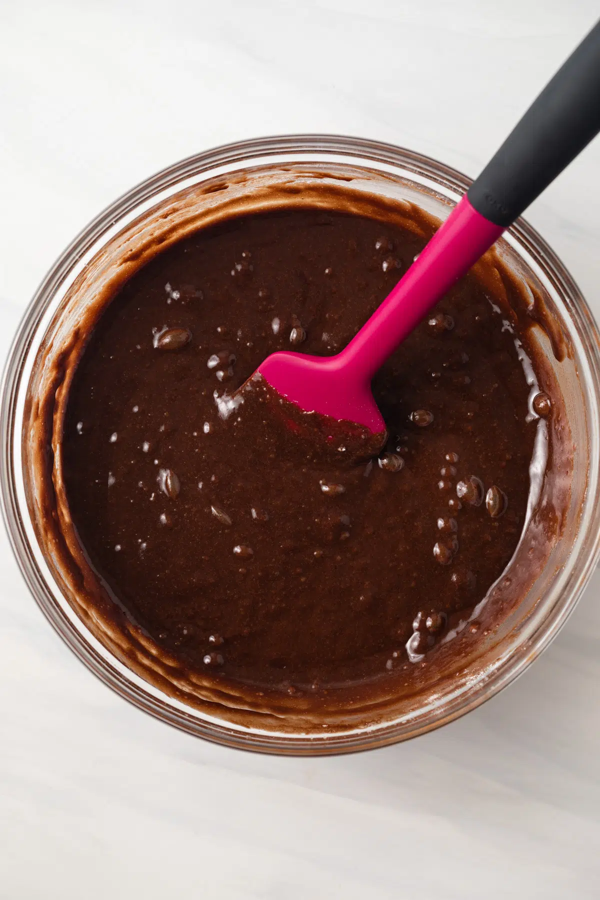 Brownie batter in a glass bowl.