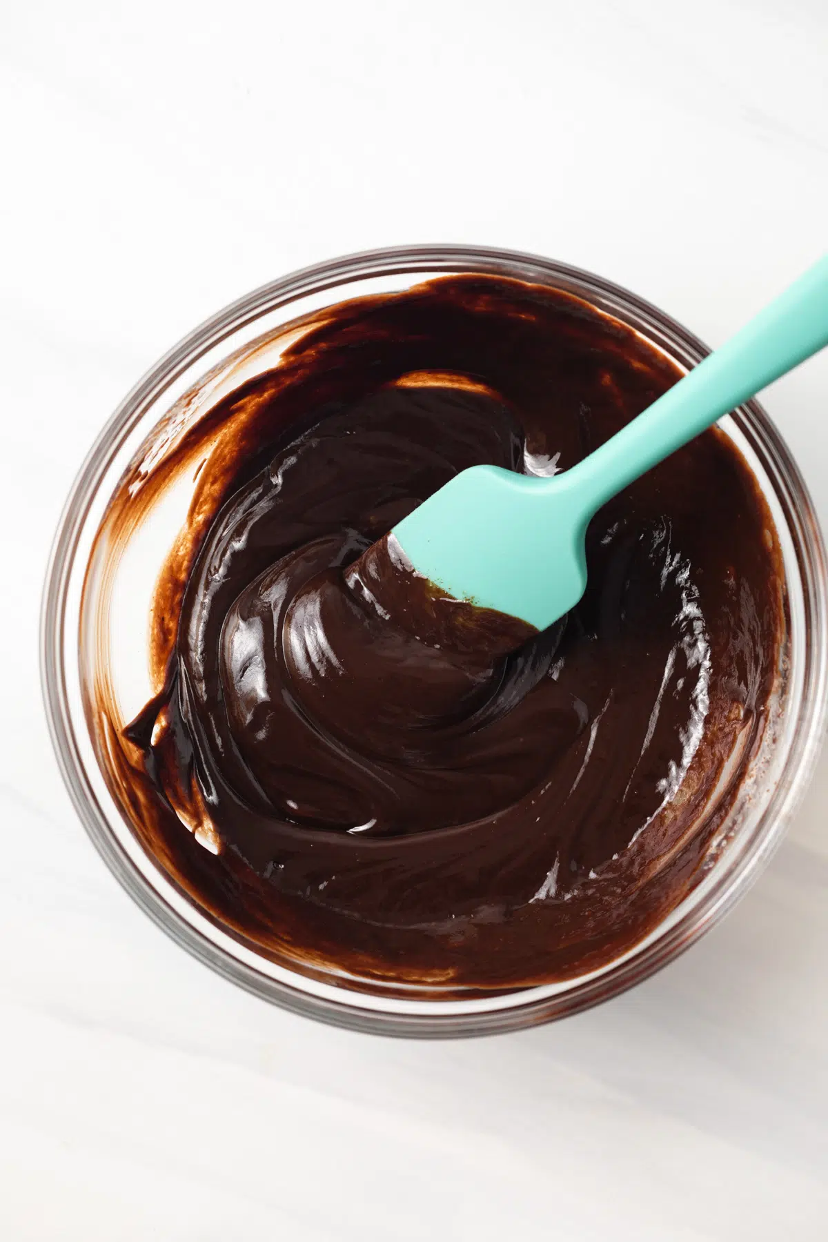 Chocolate ganache in a glass bowl.