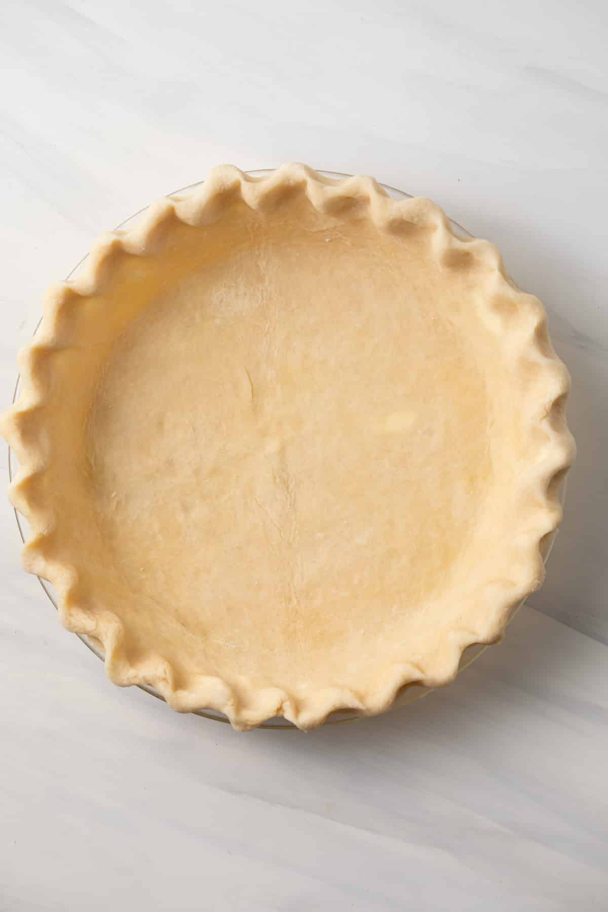 Pie crust in glass pie pan.