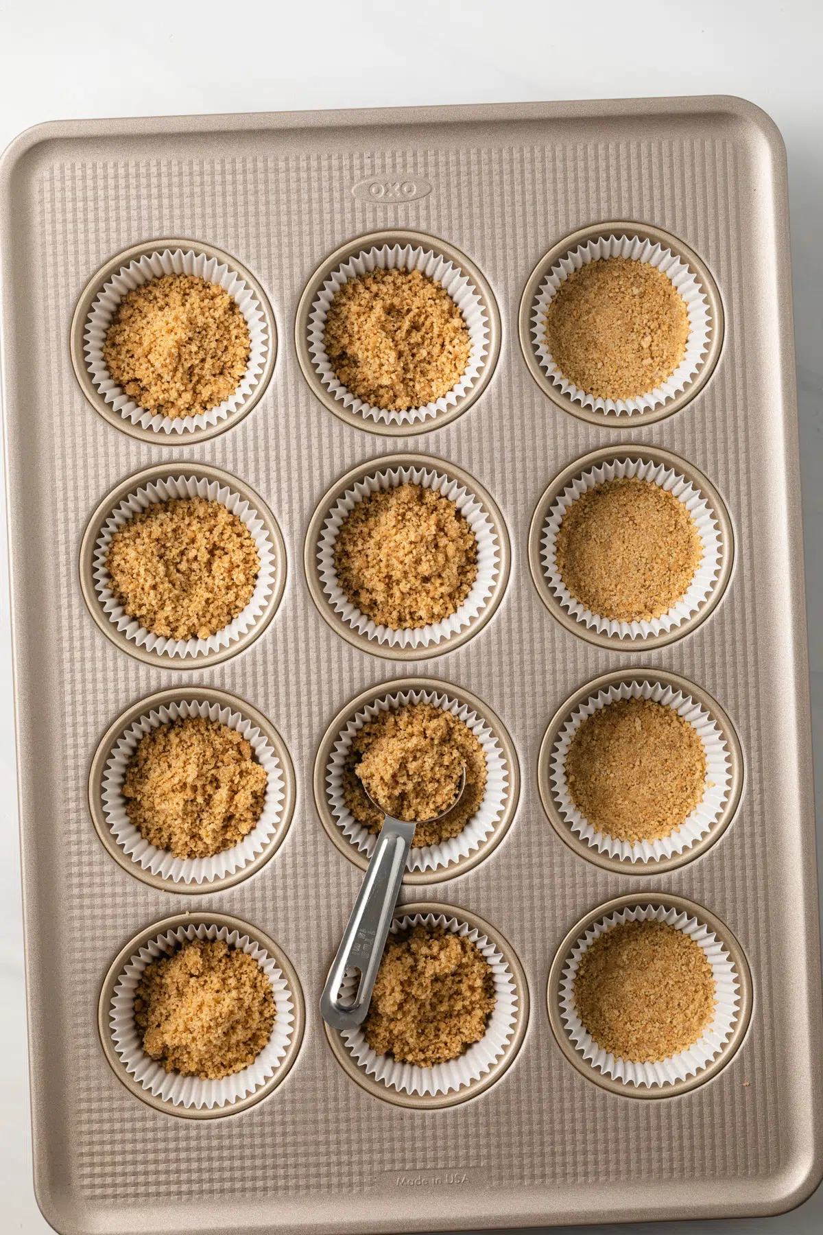 Crust added to paper lined muffin cups.