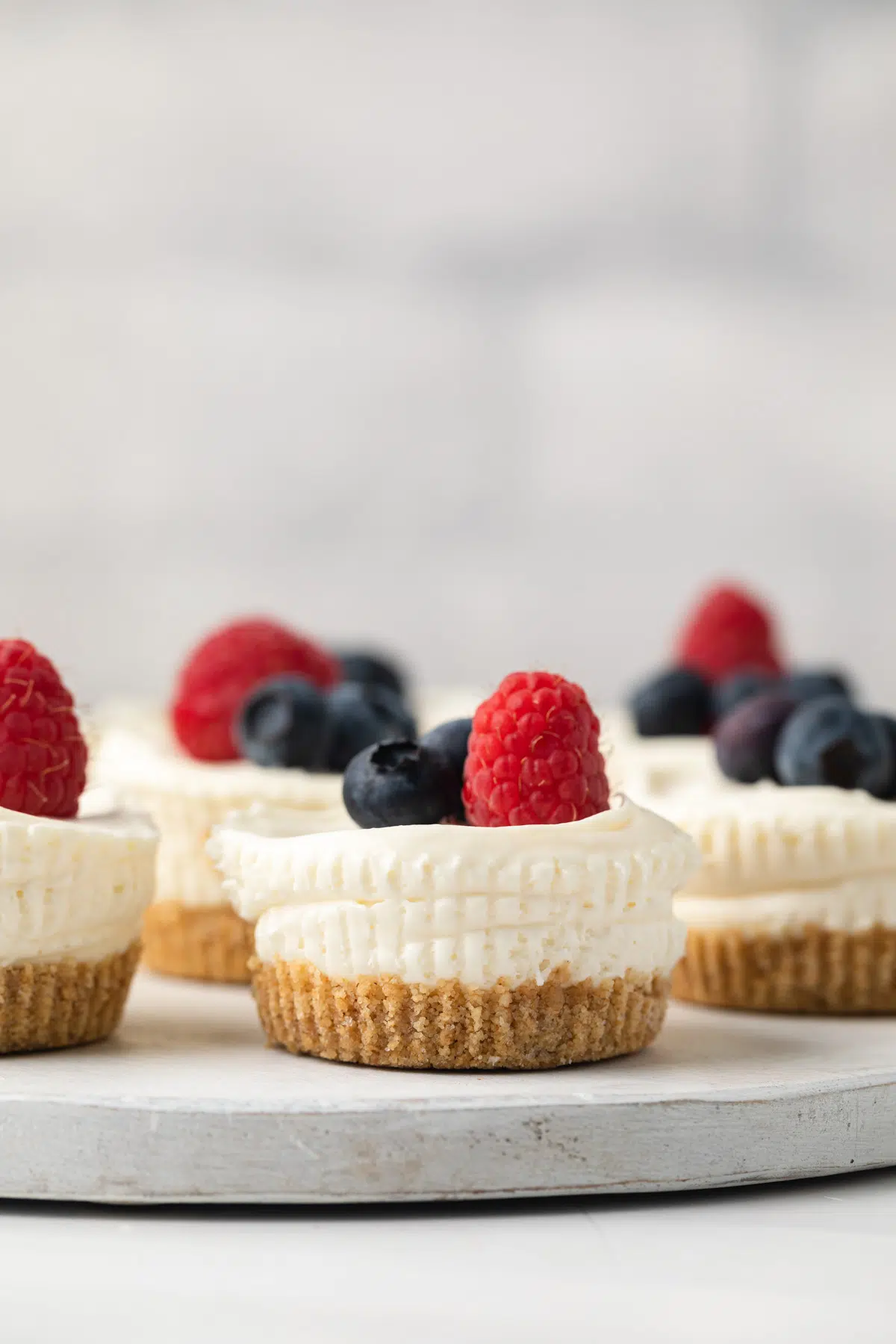 Close up of no bake mini cheesecakes on serving platter.