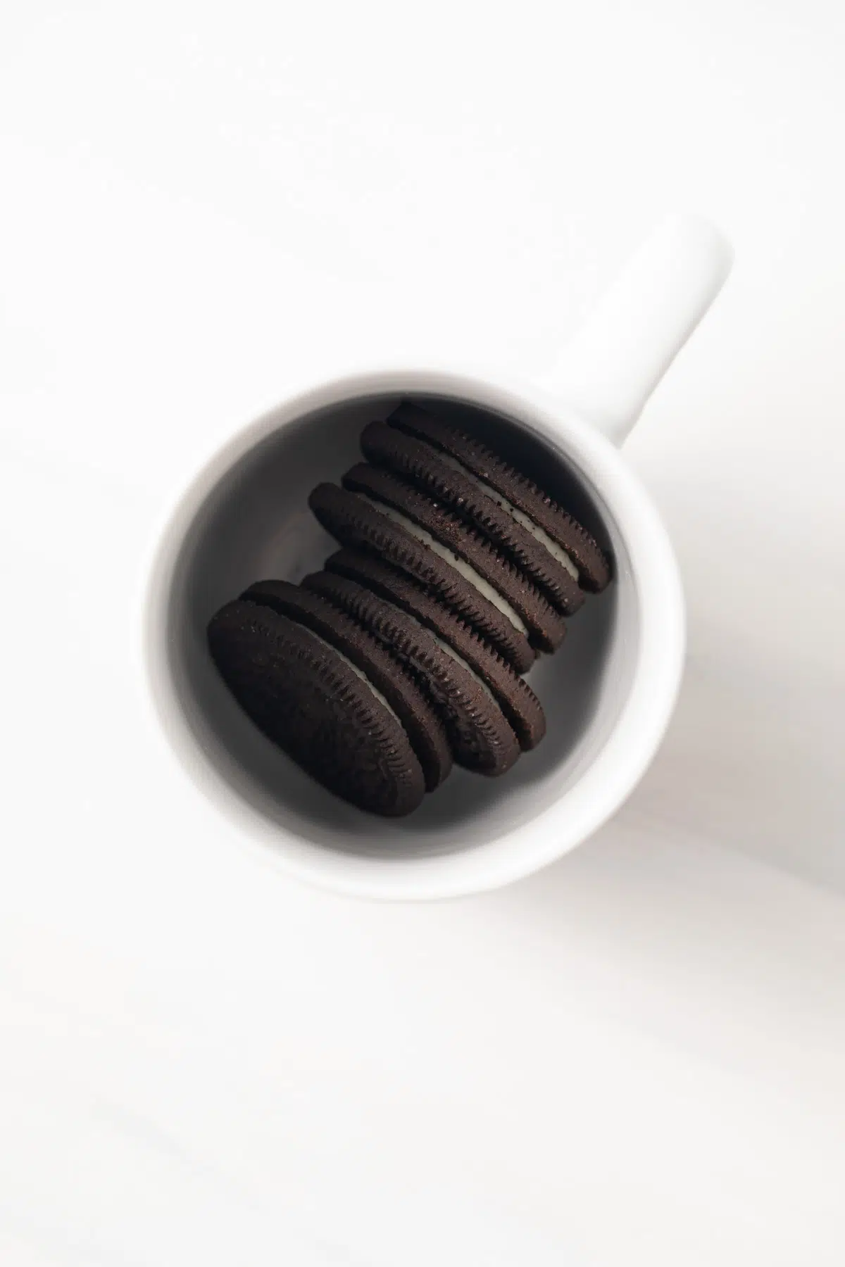 Four Oreos in a mug.