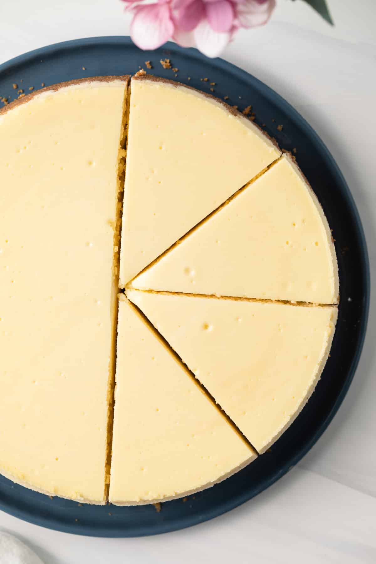Overhead of sliced cheesecake.