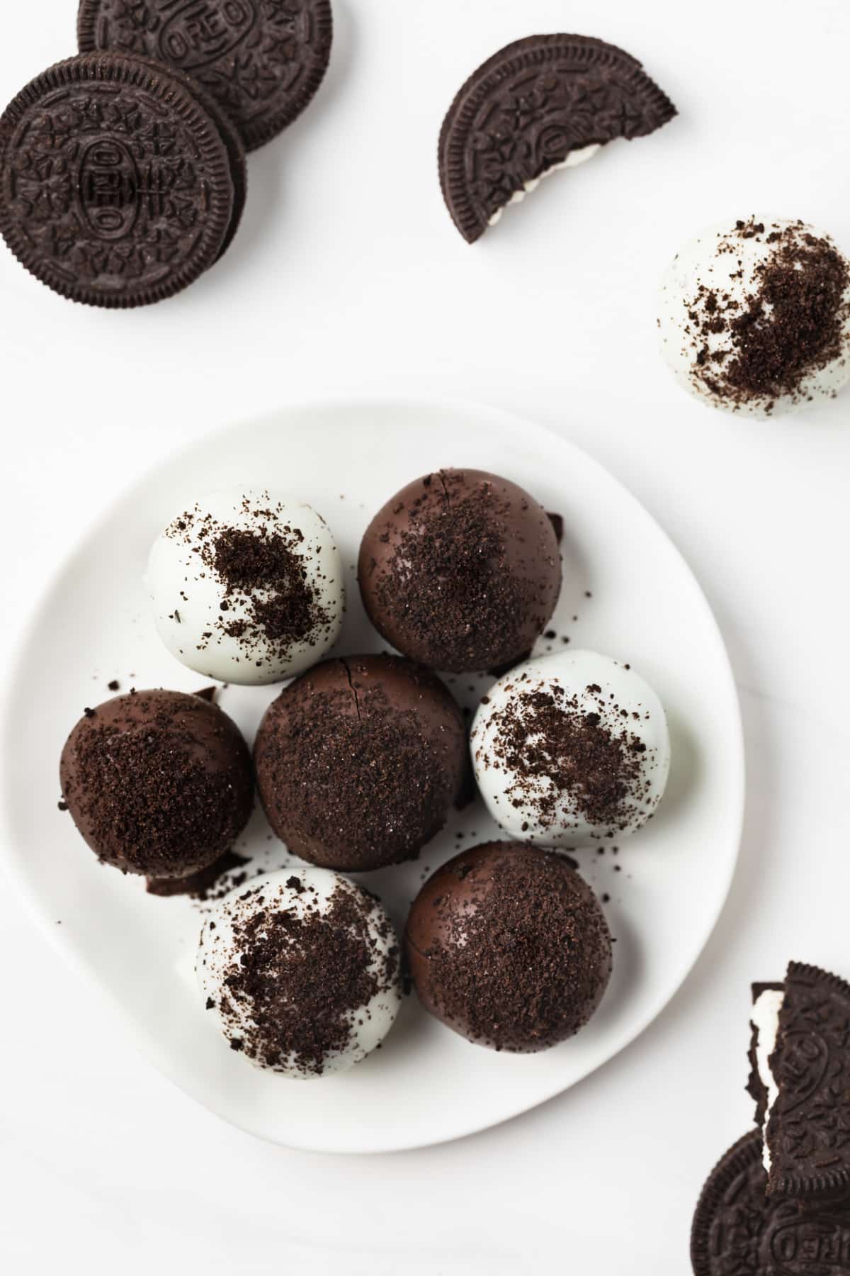 Overhead of Oreo balls on a white plate.