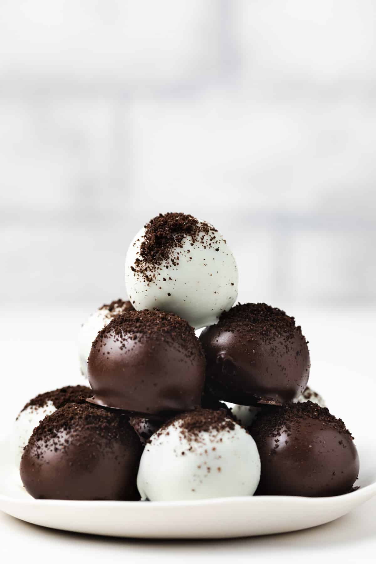Side view of Oreo balls on white plate.