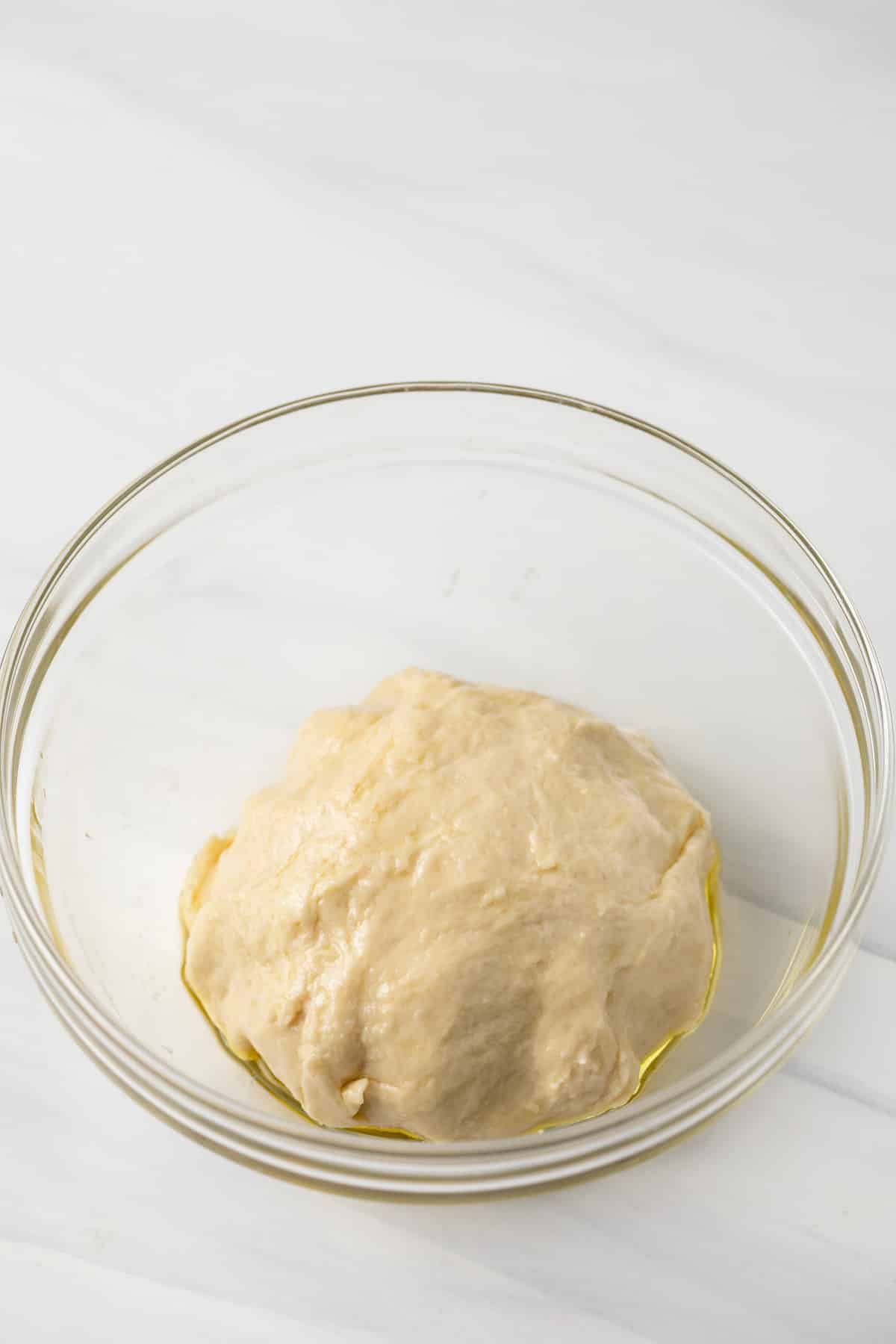 Strudel dough in a glass bowl.