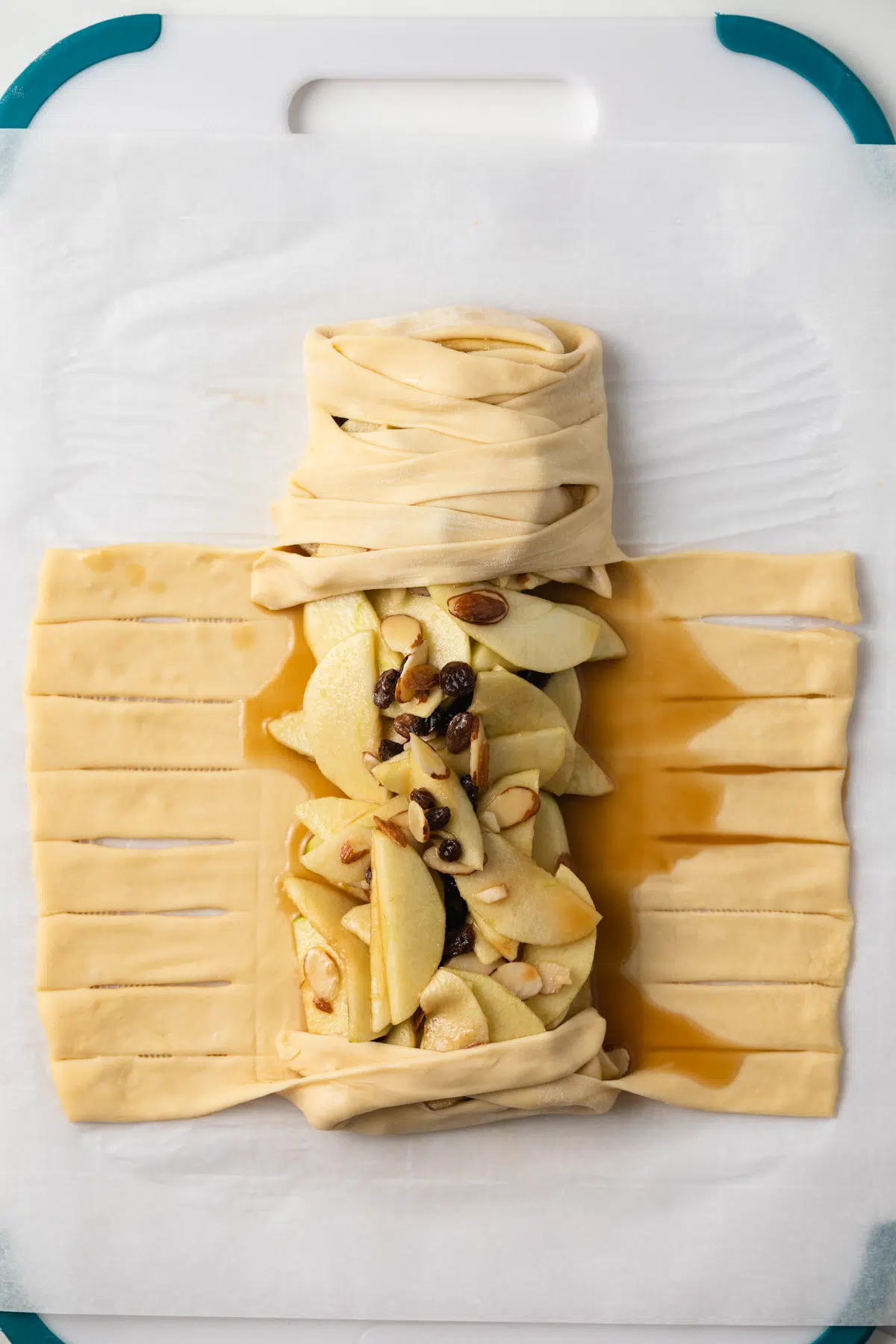 Folding strudel dough over filling.