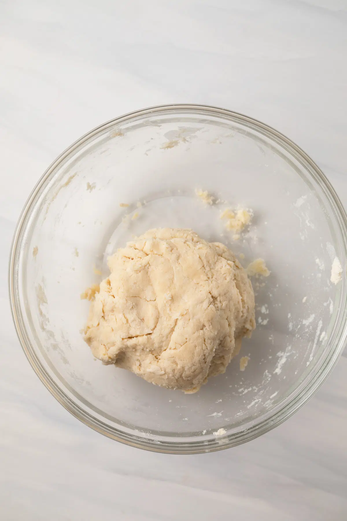 Pie dough in a glass bowl.