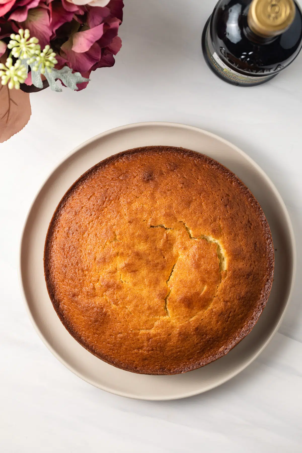 Overhead of olive oil cake on cake plate.