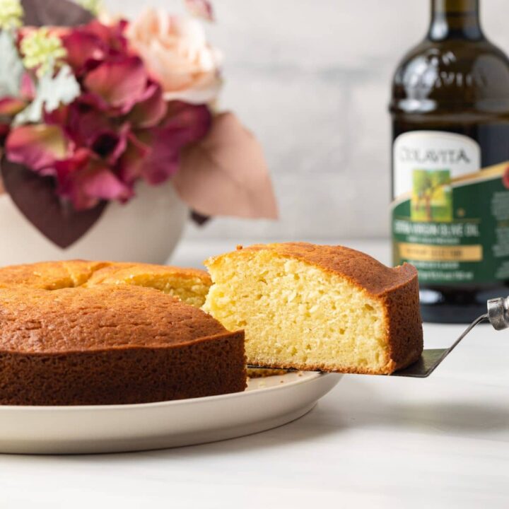 Slice being taken out of olive oil cake.