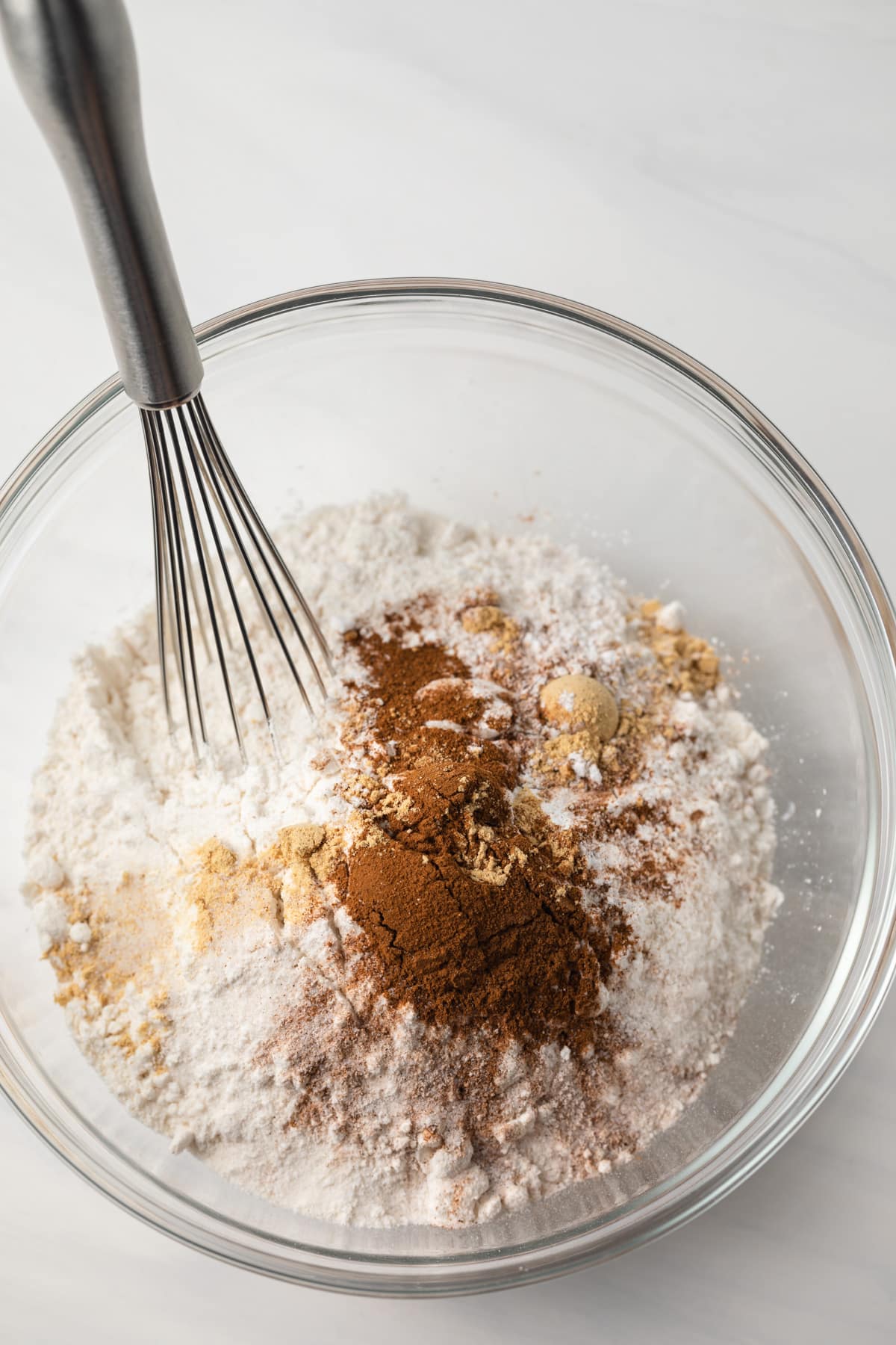 Dry ingredients mixed in a glass bowl.