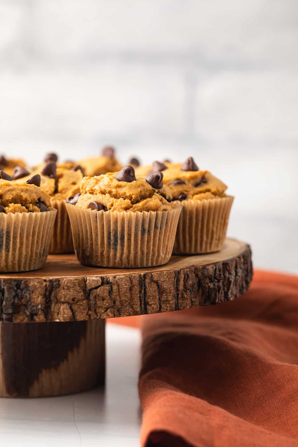 Side view of pumpkin chocolate chip muffins.