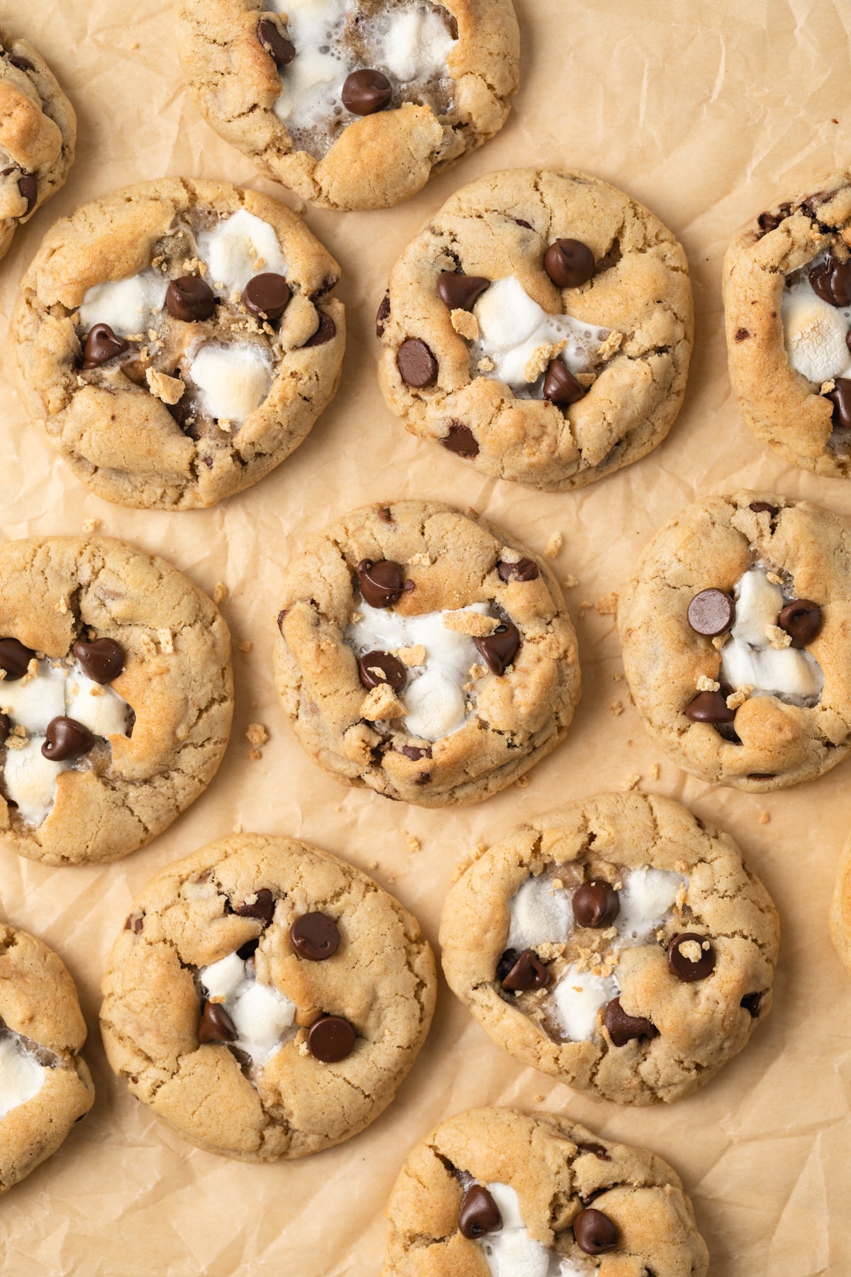 Overhead of s'mores cookies on brown parchment paper.