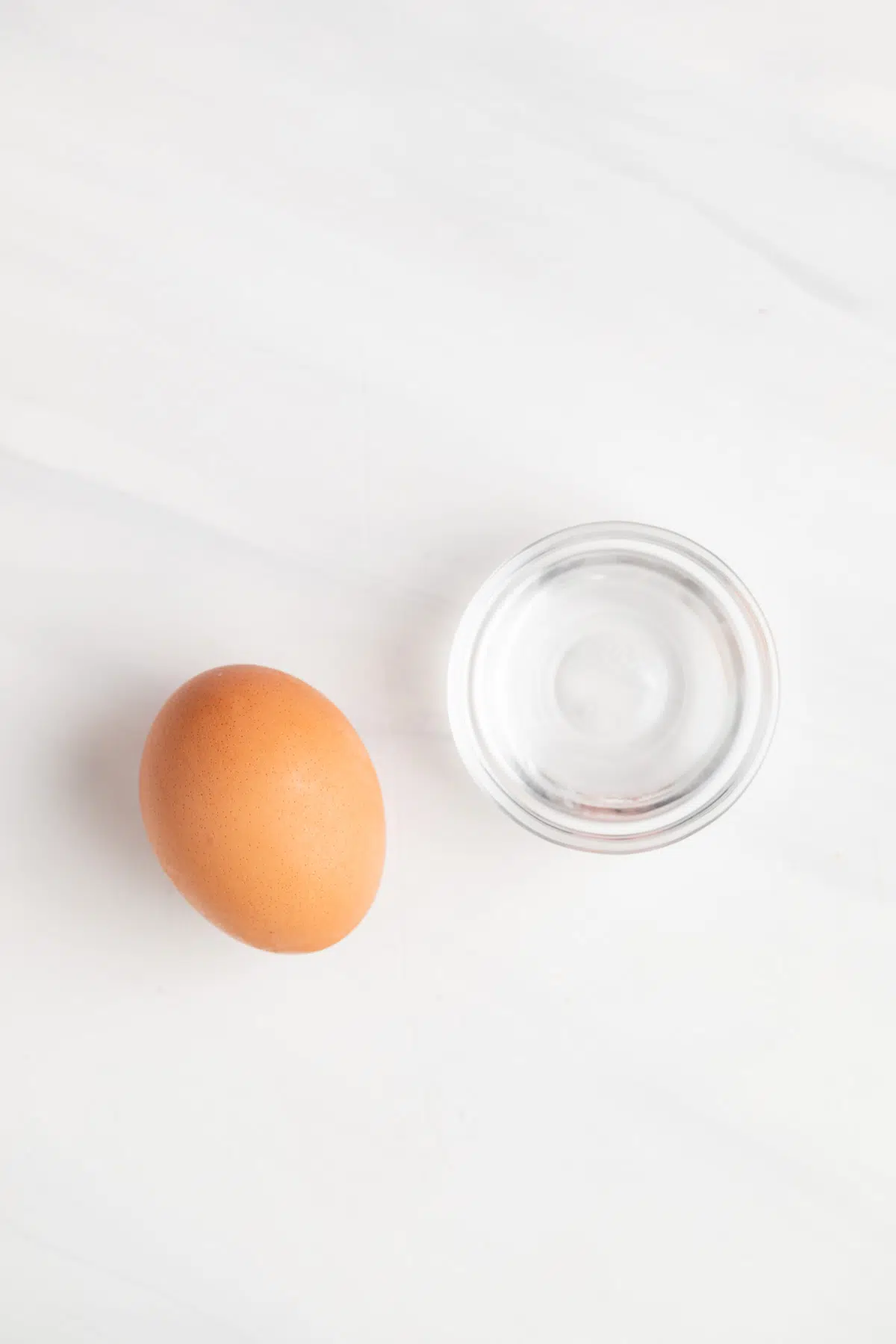 Egg and water in glass bowl.