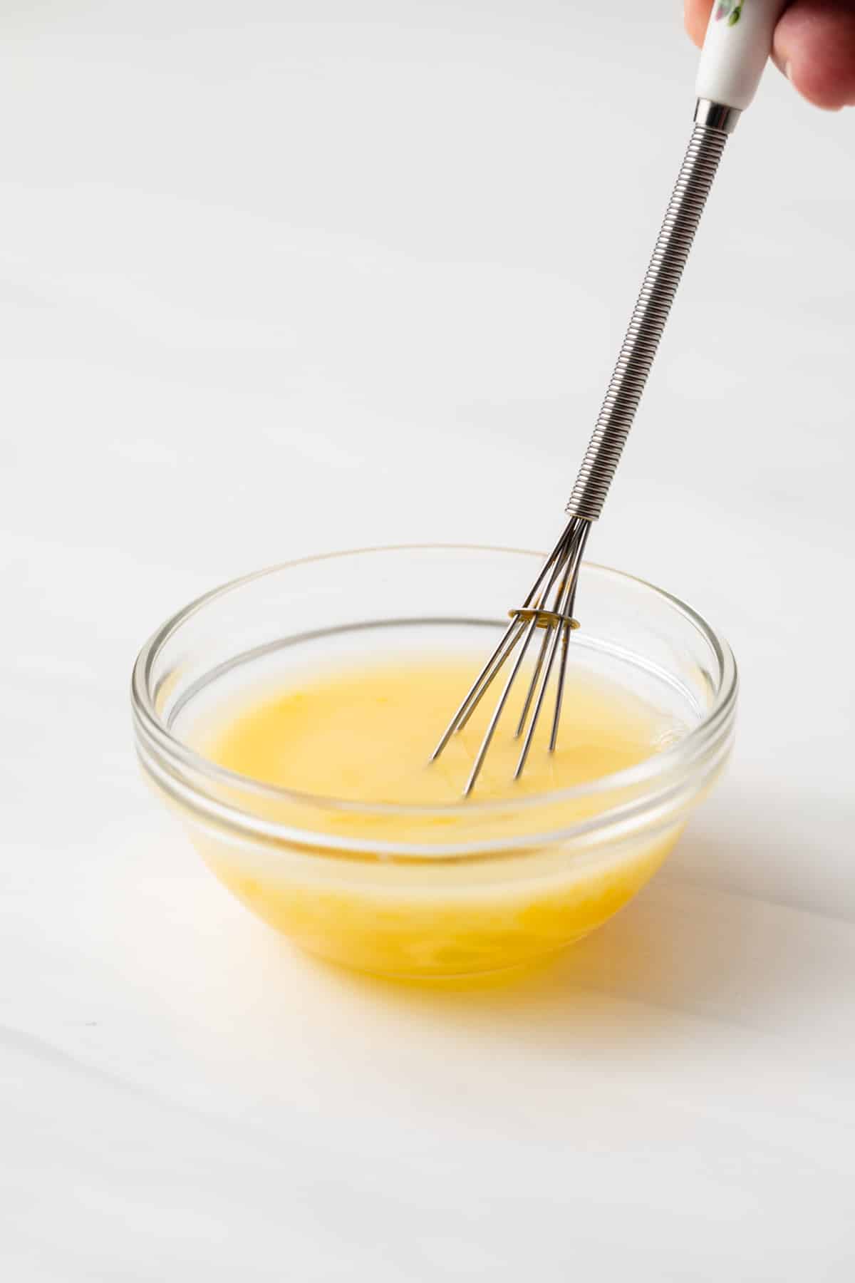 Whisking egg and water together.