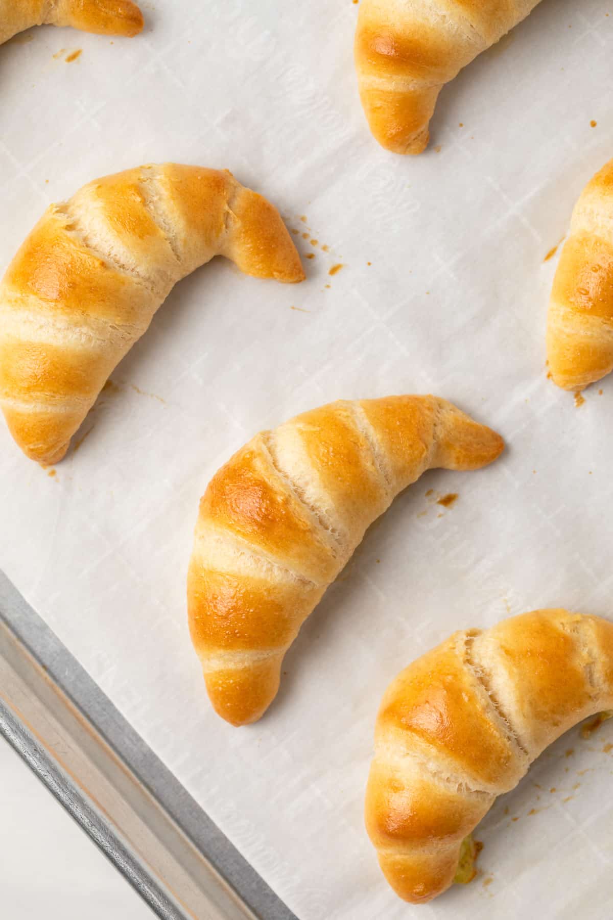 Close up of baked crescent rolls with egg wash.