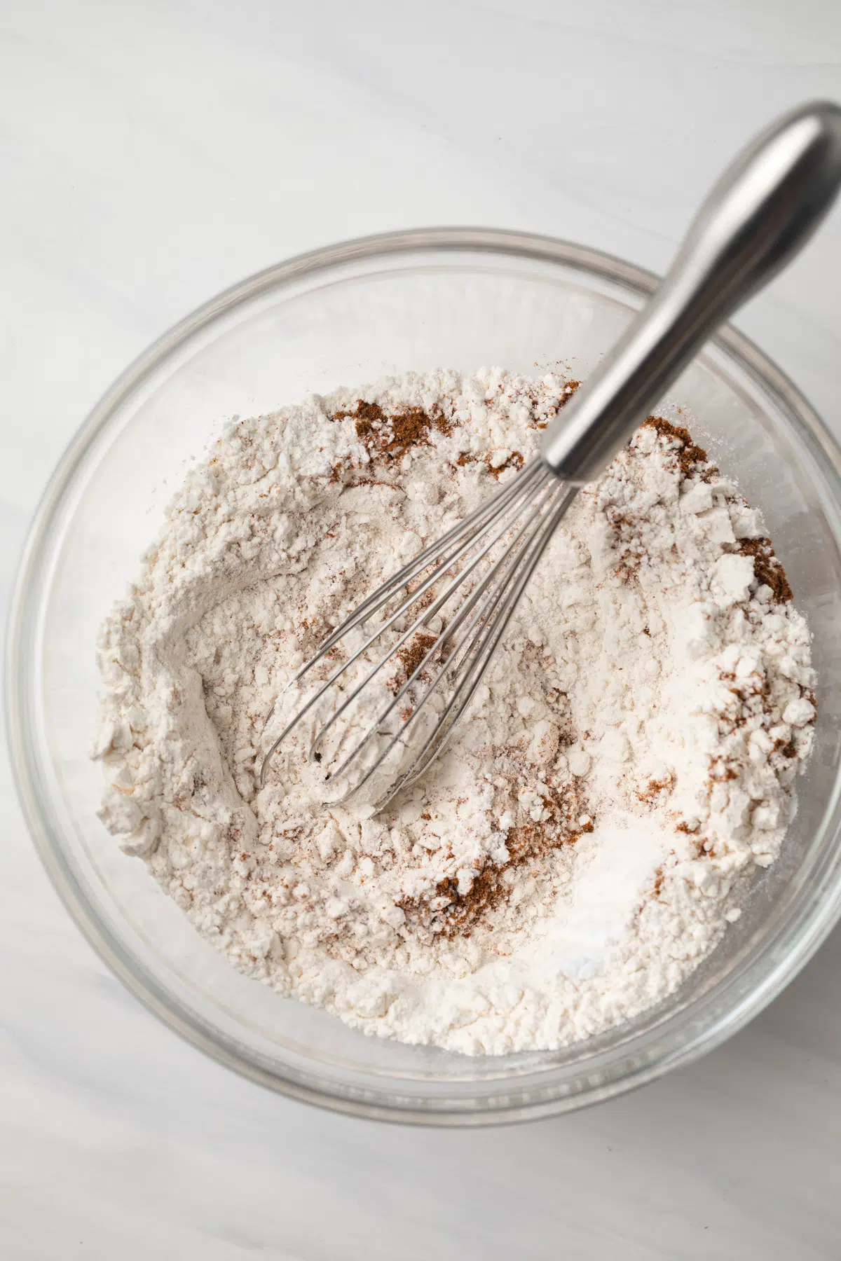 Dry ingredients mixed in glass bowl.