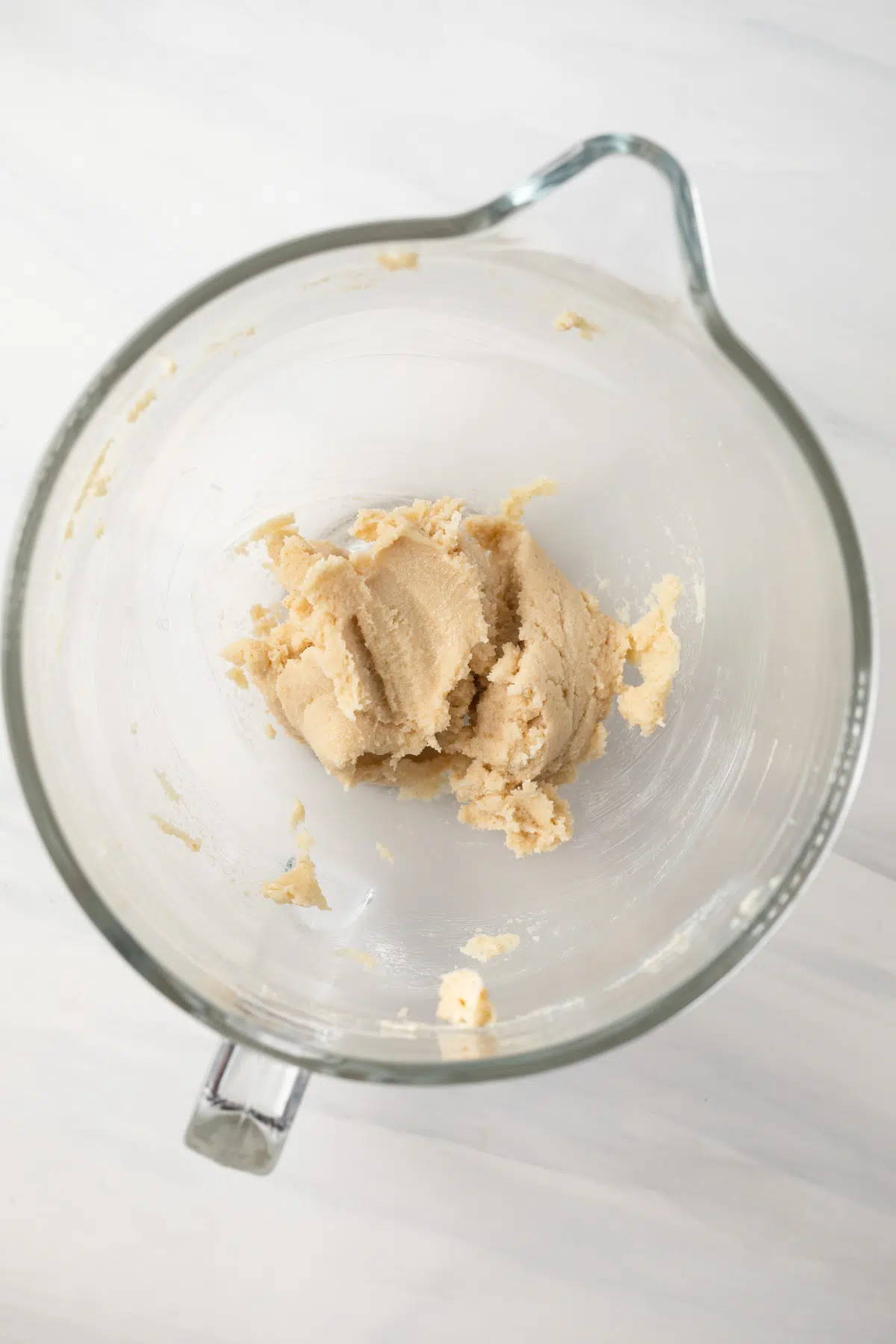 Creamed butter and sugar in glass bowl.