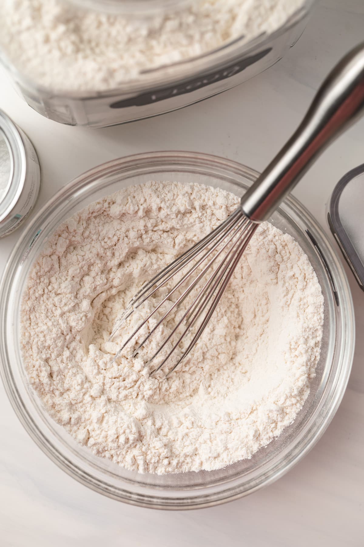Close up of self raising flour whisked in a bowl.